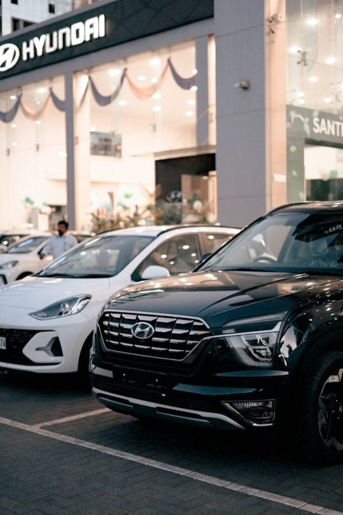 Photo of New Cars Parked in Front of a Car Dealership